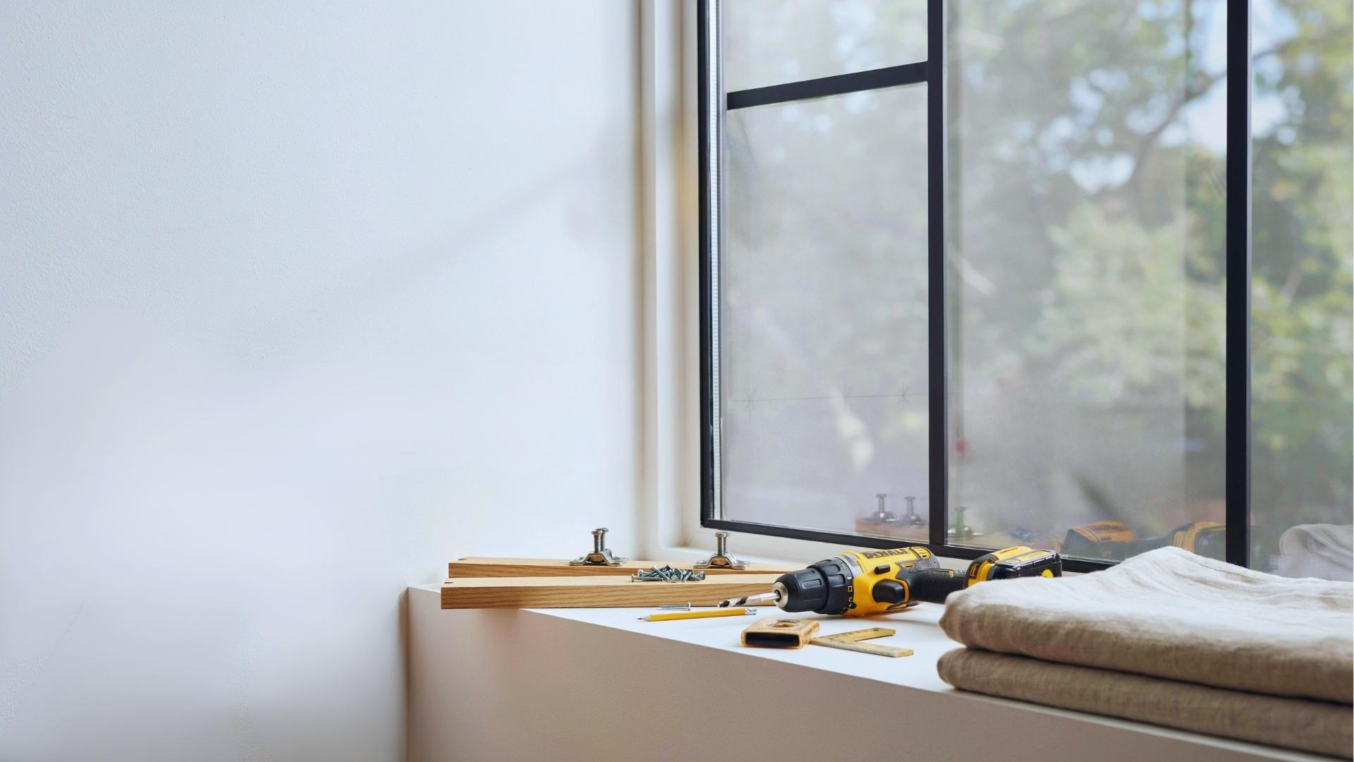 DIY setup showing step by step curtain rod bracket installation with measuring drilling and leveling tools on window wall.