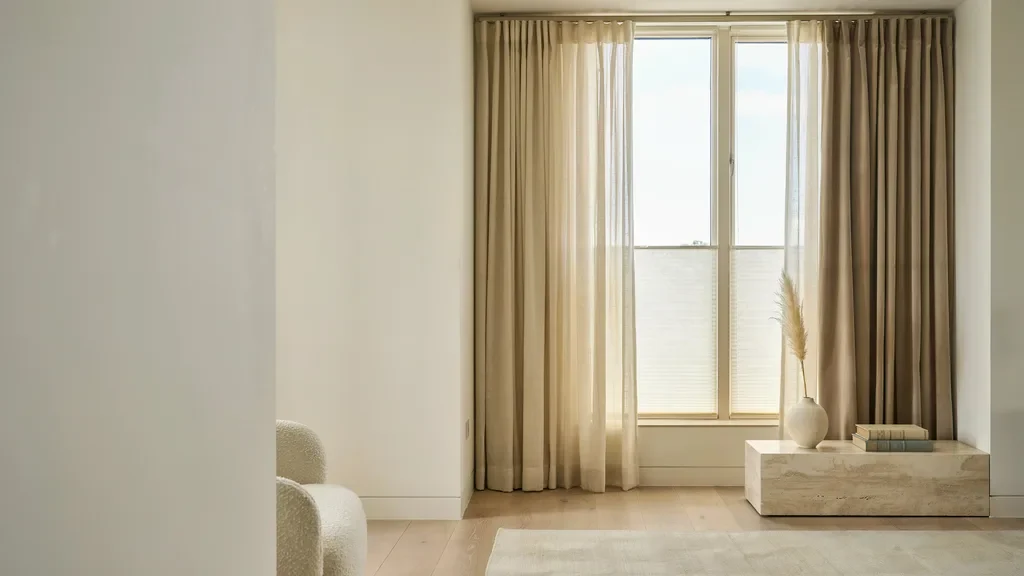 Double layered curtains with hidden blinds in a seamless luxury interior