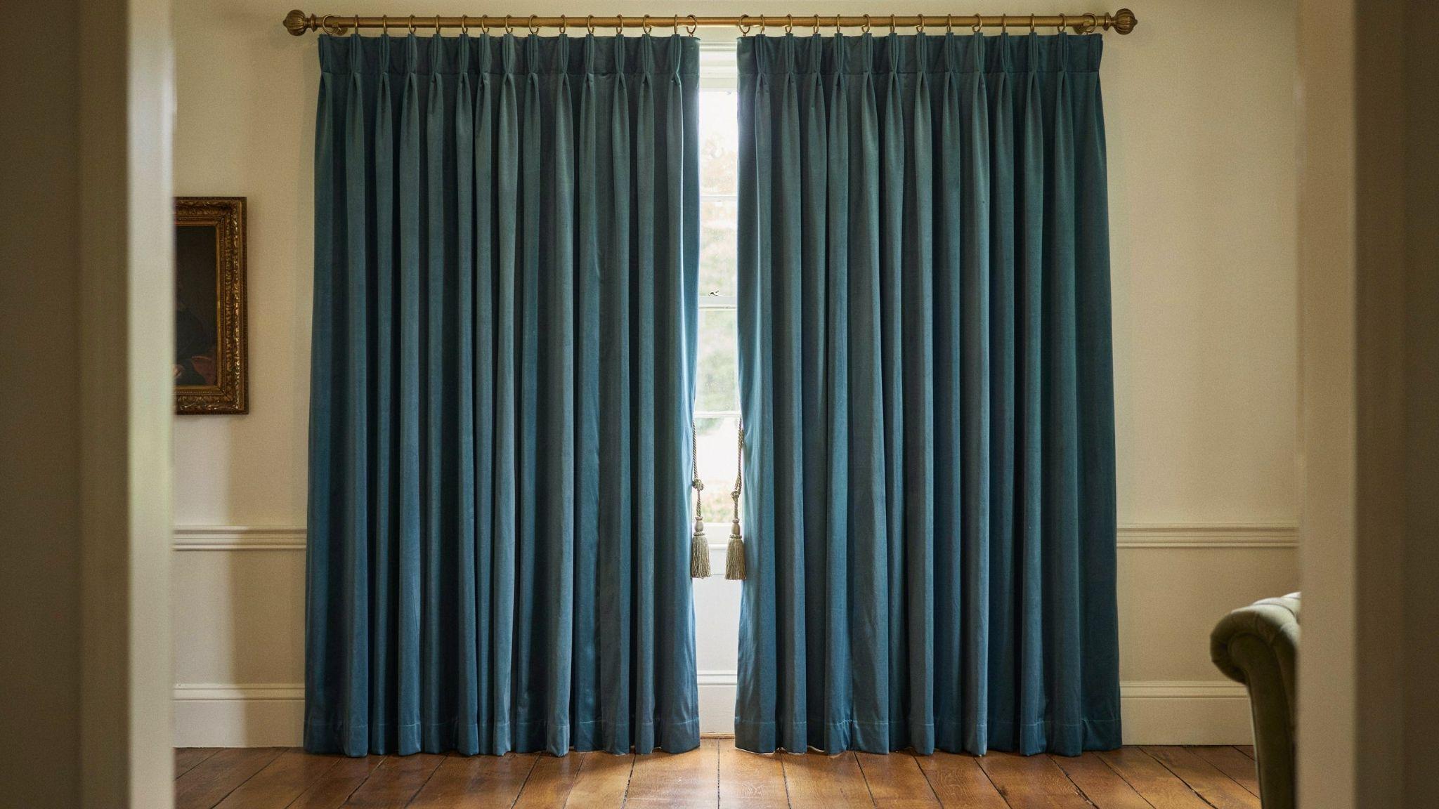 Triple pinch pleat curtains creating a full and structured window treatment design