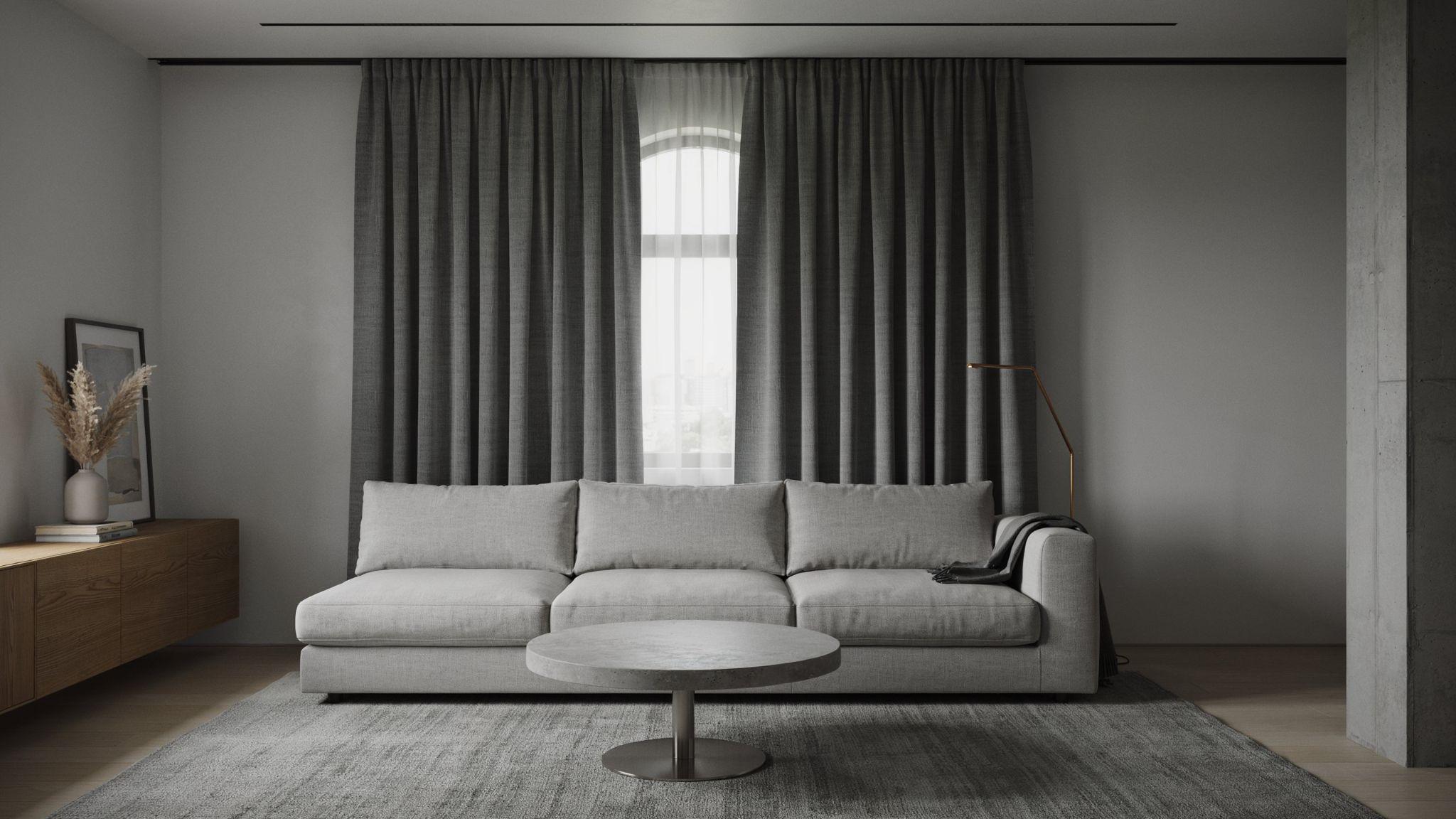 "Monochromatic gray living room with charcoal curtains creating layered tonal depth and a moody modern aesthetic"