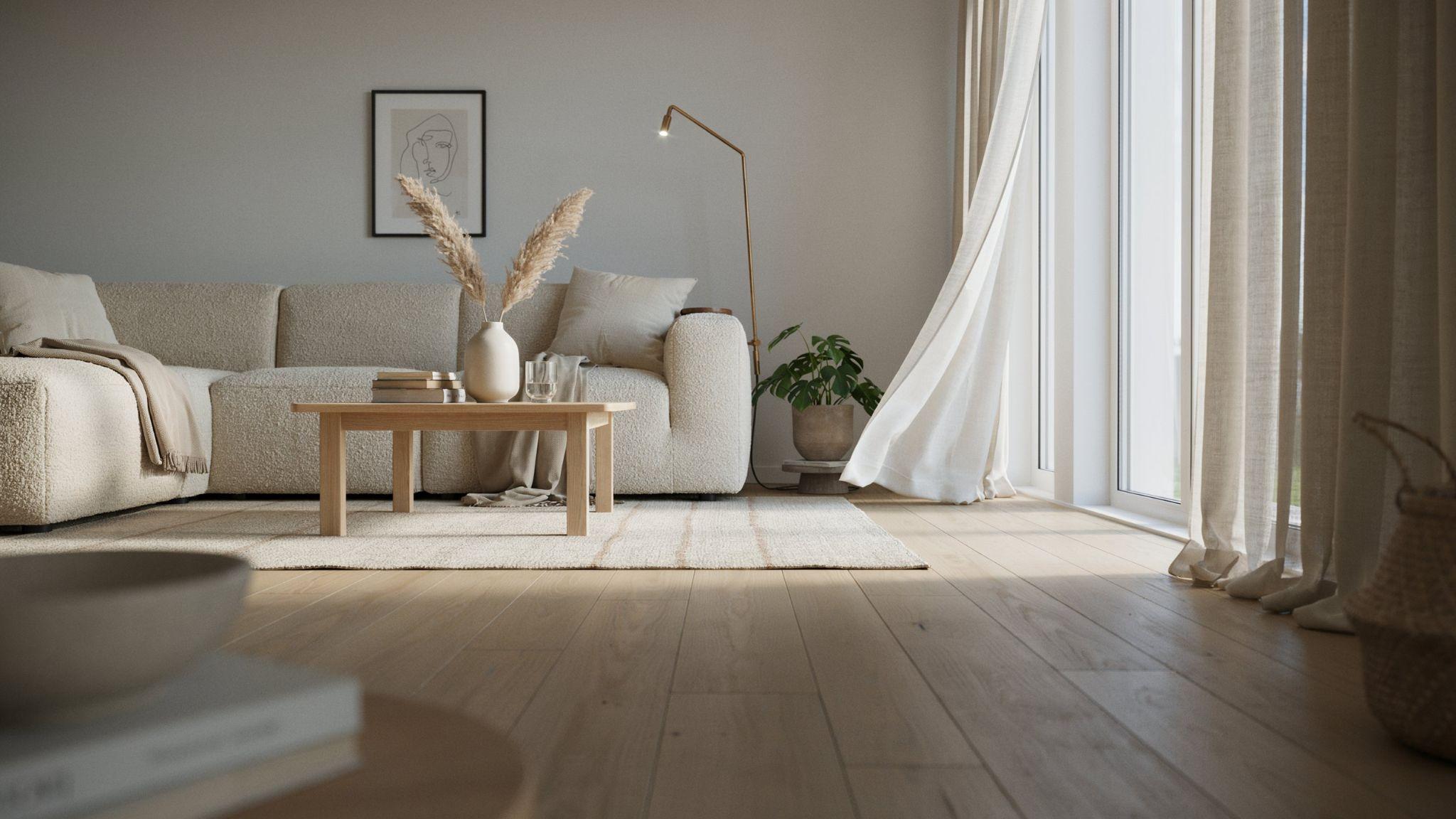 "Modern gray living room with off-white cream curtains softening cool wall tones under warm natural light"