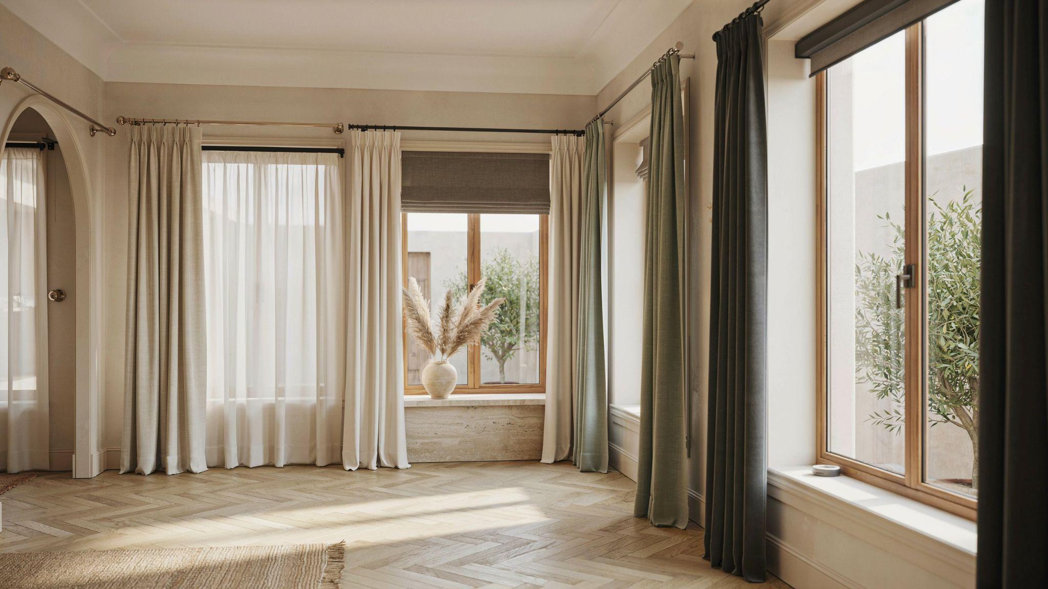 Alt text: Various curtain rods displayed with stylish curtains in modern interior design showroom setting