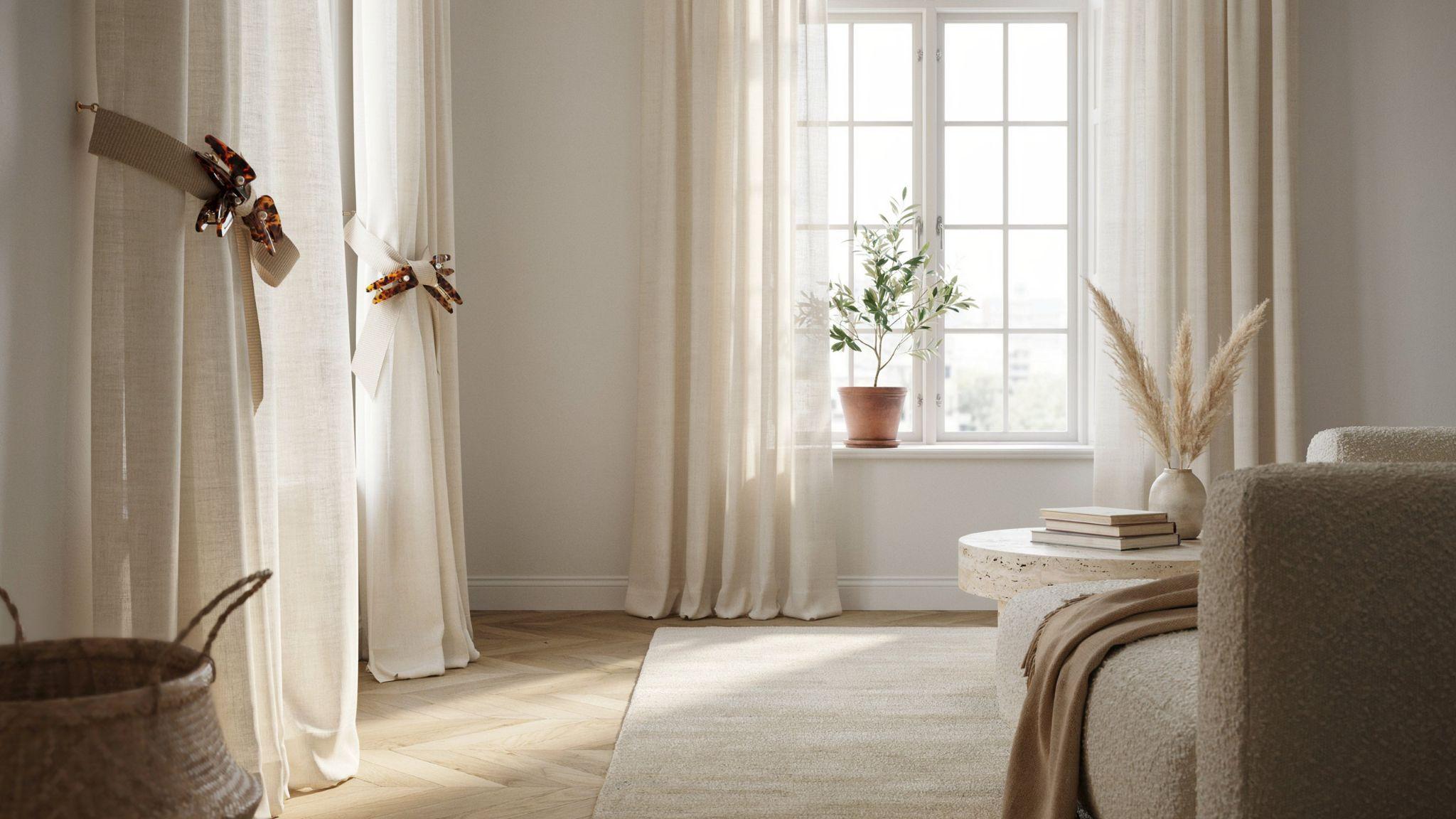 Minimalist space with sheer curtains gathered by wide beige fabric bands secured with large tortoiseshell hair claw clips.