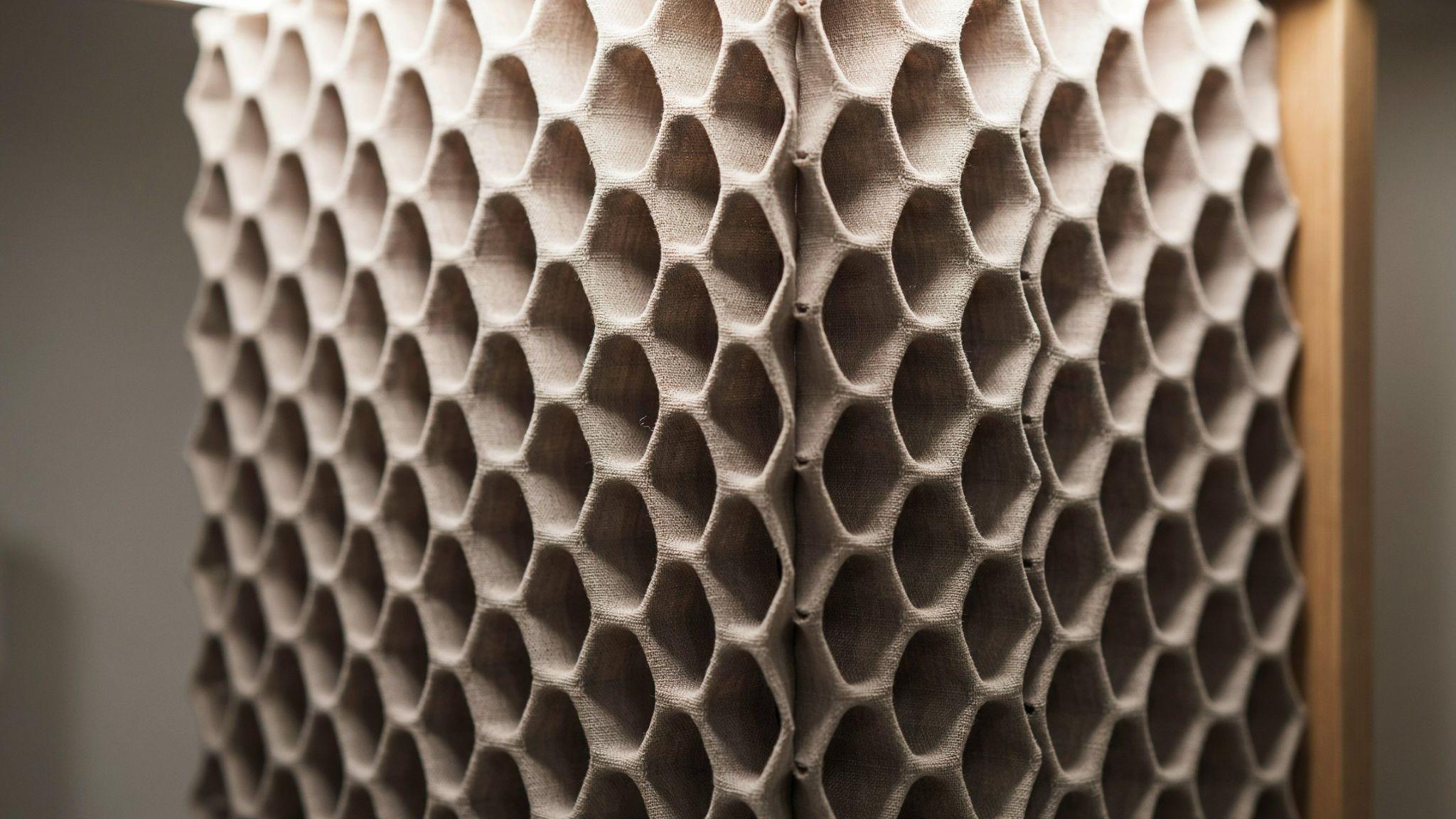 Close up honeycomb blinds revealing cellular structure with dust inside delicate fabric cells