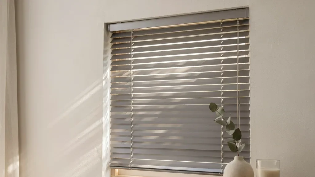 Close-up of Venetian blinds showing horizontal slats that can tilt to control light and privacy.