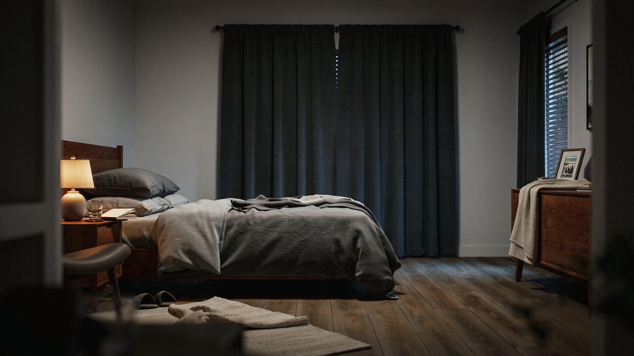 Blackout curtains combined with cellular shades in a bedroom.