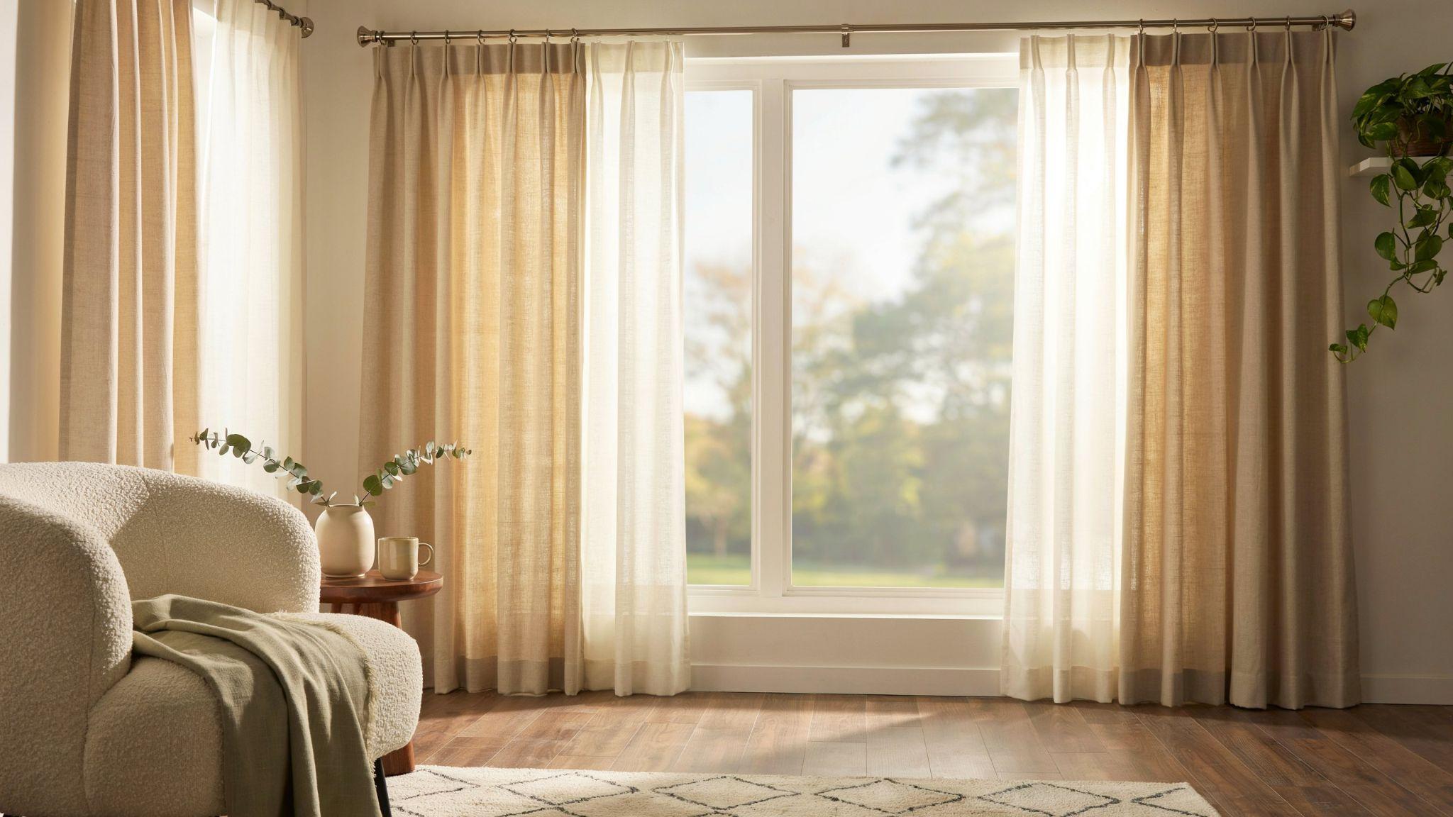 Tension rod holding sheer curtains behind decorative drapes for a renter-friendly layered look