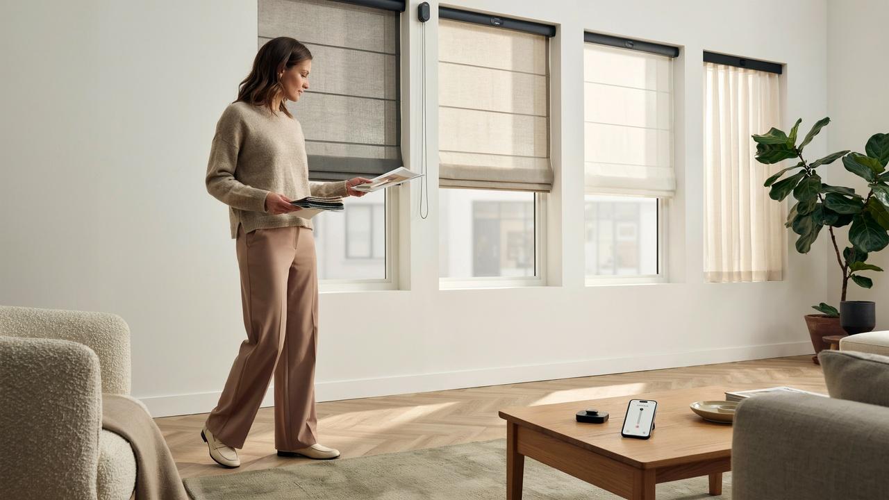A homeowner comparing motorized blinds with both remote and manual control options in a modern interior.
