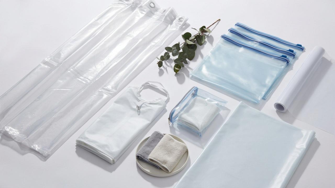 Collection of PEVA material products including shower curtain, storage bags, and waterproof packaging.