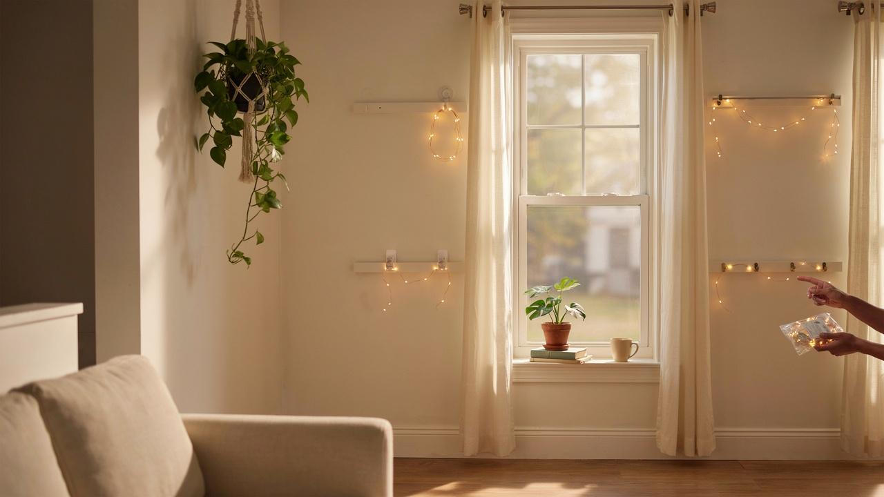 Different methods for hanging curtain lights displayed around a window in a modern home setting.