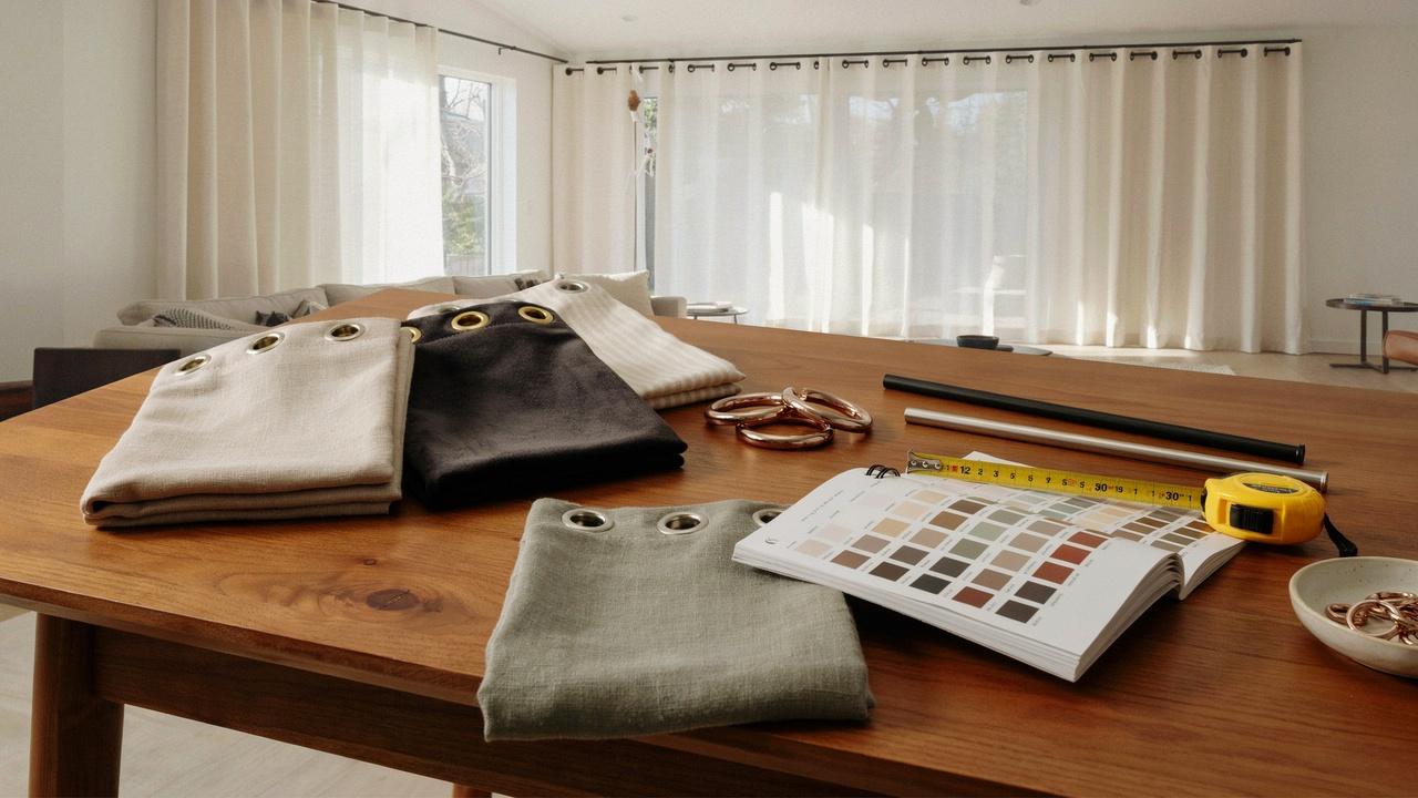 Curtain fabric samples, measuring tools, and elegant grommet curtains illustrating a homeowner's guide to choosing the right curtains.