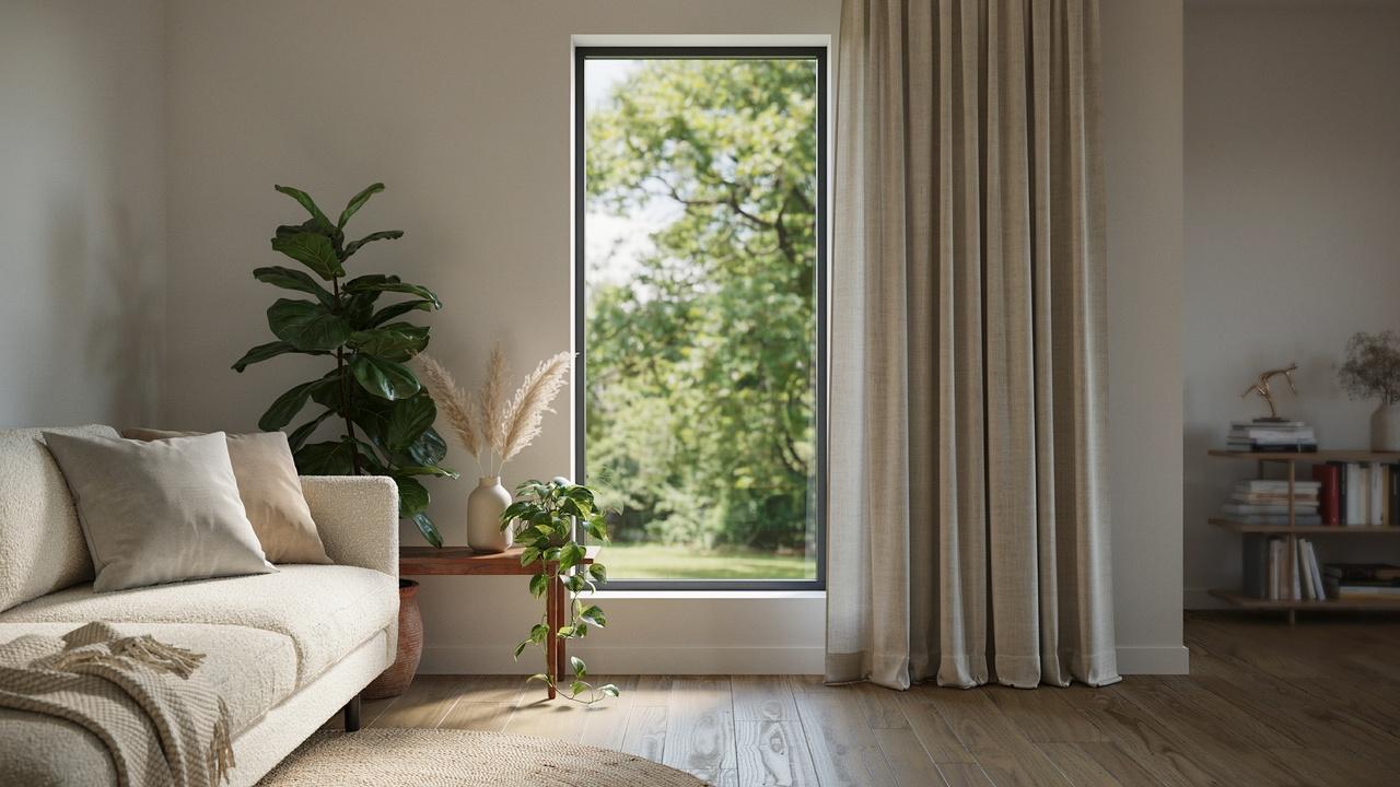 Modern living room window featuring a single curtain panel gathered to one side.