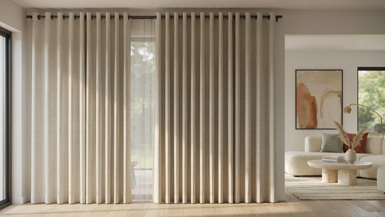 Classy eyelet curtains with metal grommets and evenly spaced folds in a modern living room.