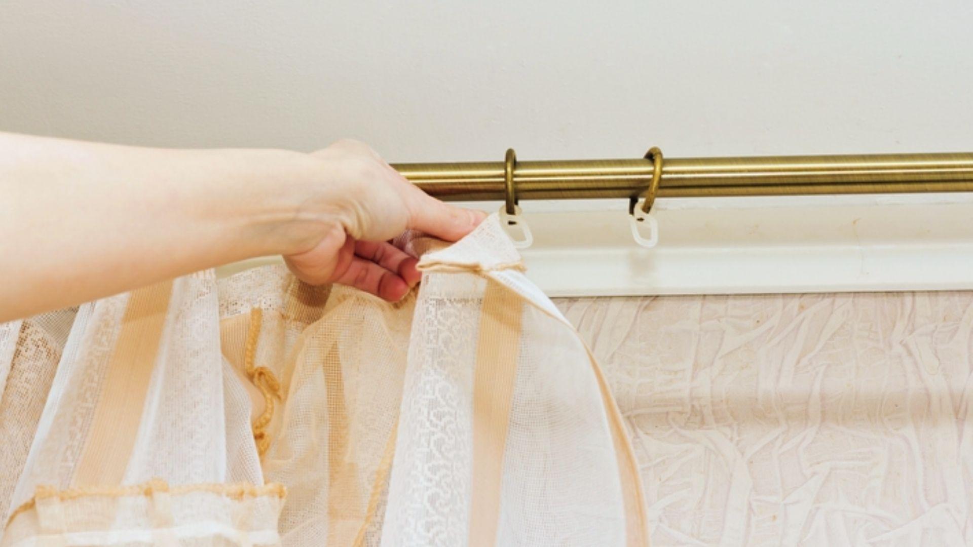 Hand hanging sheer lace curtain with hooks on brass curtain rod for window decoration