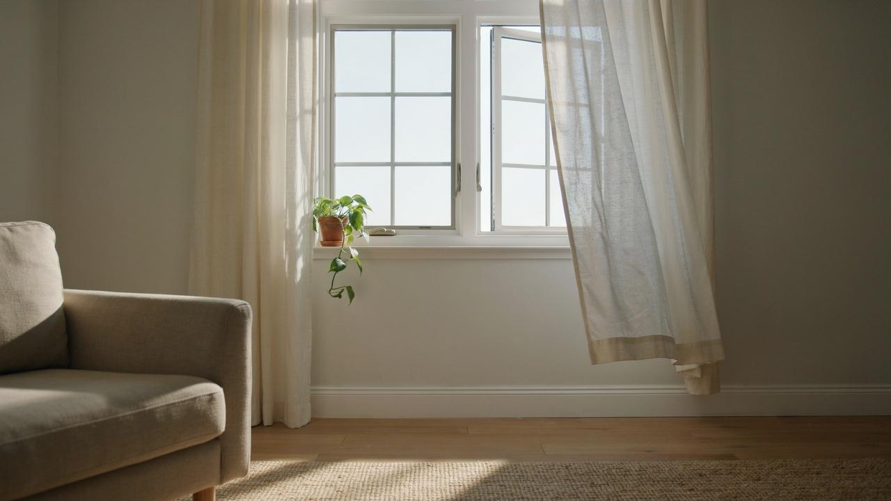 Double-hung window with movable sashes positioned to allow fresh air into a room.
