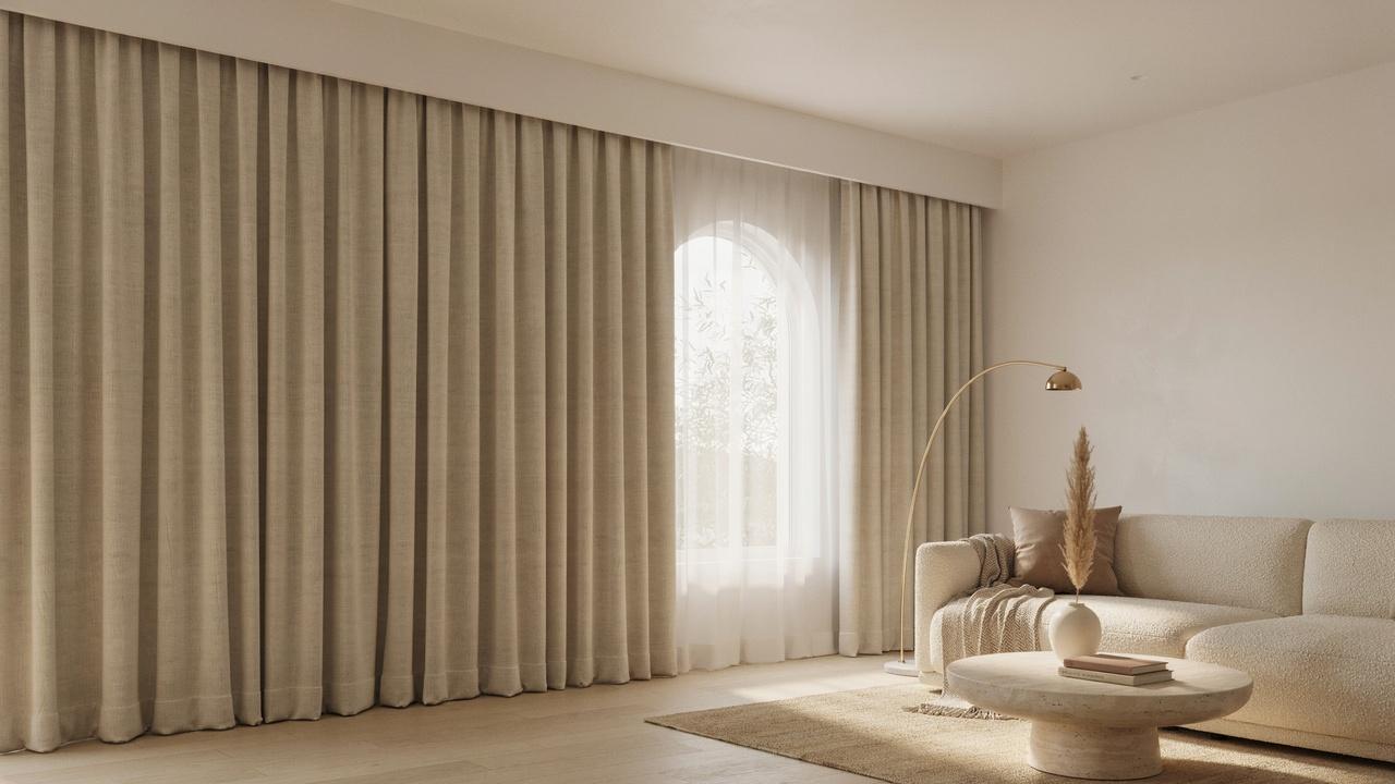 Concealed ceiling curtain track with floor-to-ceiling curtains in a minimalist room.