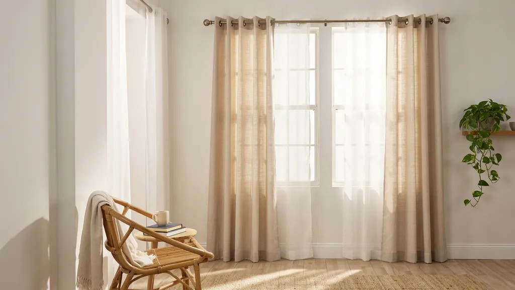 Casual tab top curtains with visible fabric loops on a rod.