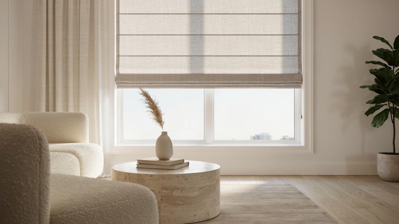 Roman shade being raised as its fabric folds into horizontal pleats over a living room window.