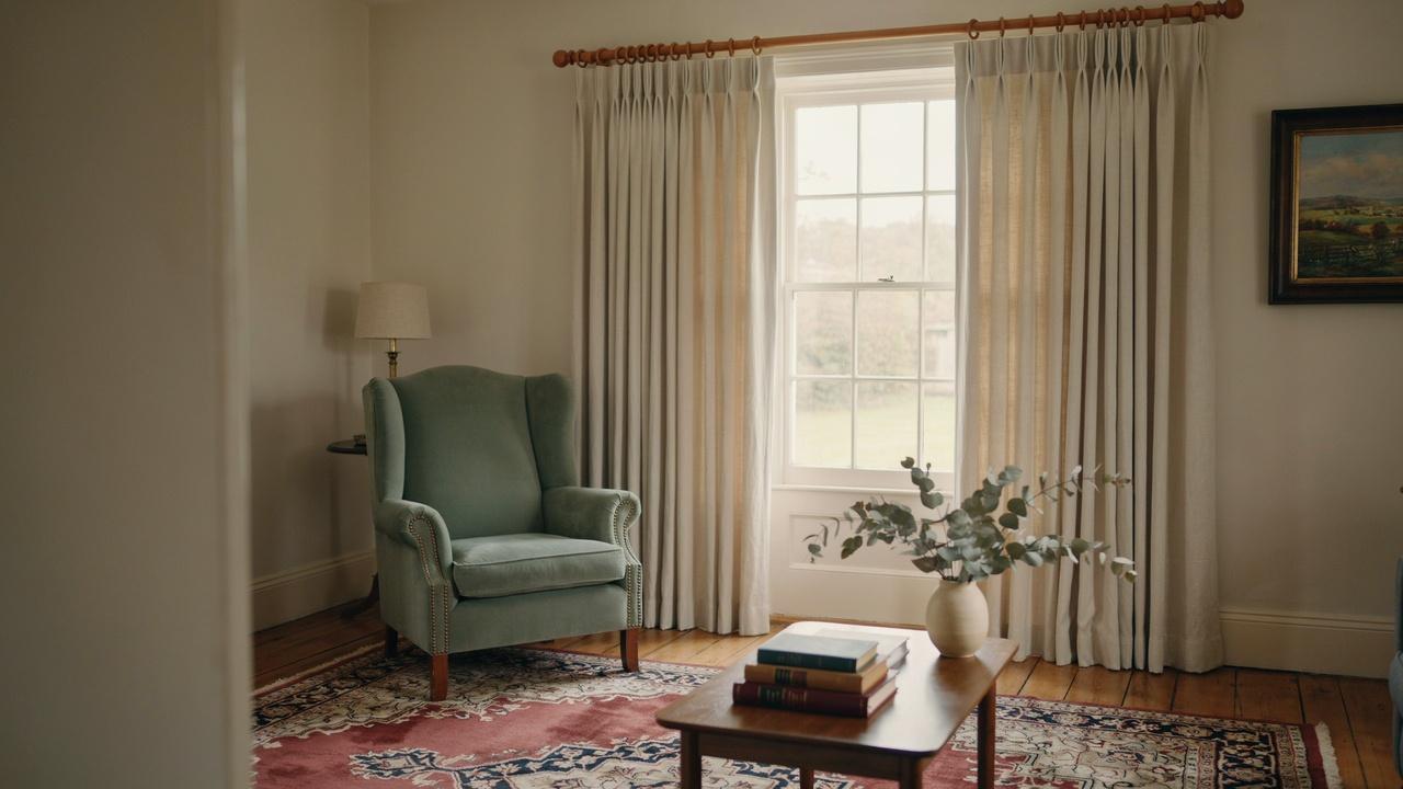 Pencil pleat curtains with narrow gathered folds across the top.