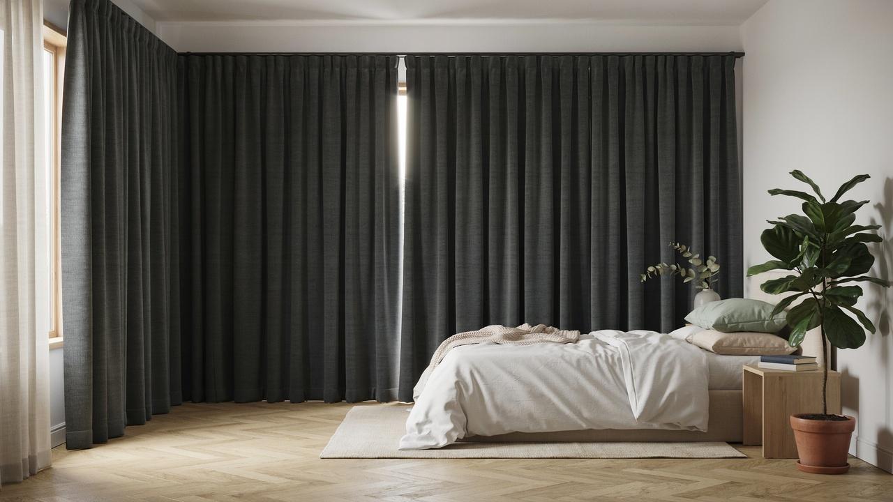 Blackout curtains block sunlight and reduce heat entering a bedroom through the window.