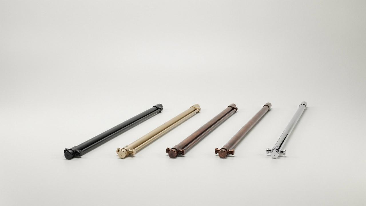 Five double curtain rods in different finishes black gold bronze brown chrome on white background studio shot.