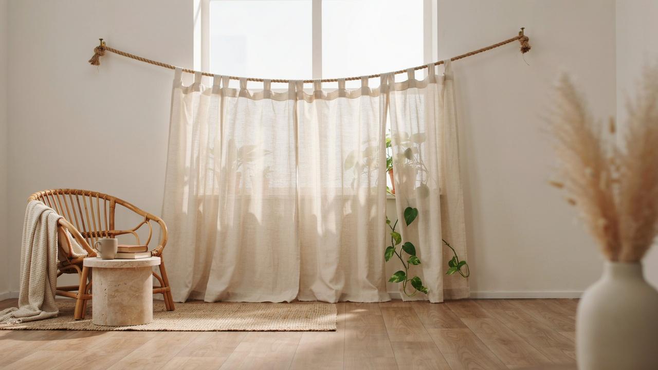 Natural rope used as a simple curtain rod for sheer curtains.
