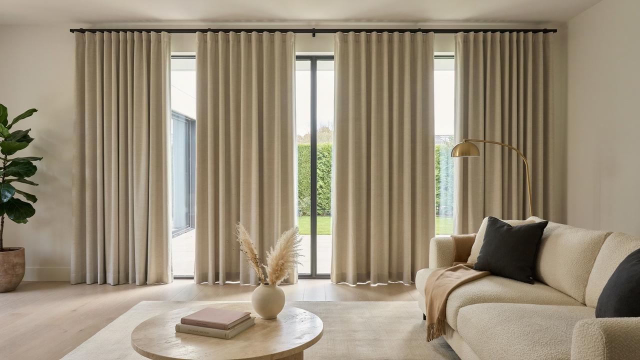 Large flat panel curtains covering wide sliding glass doors.