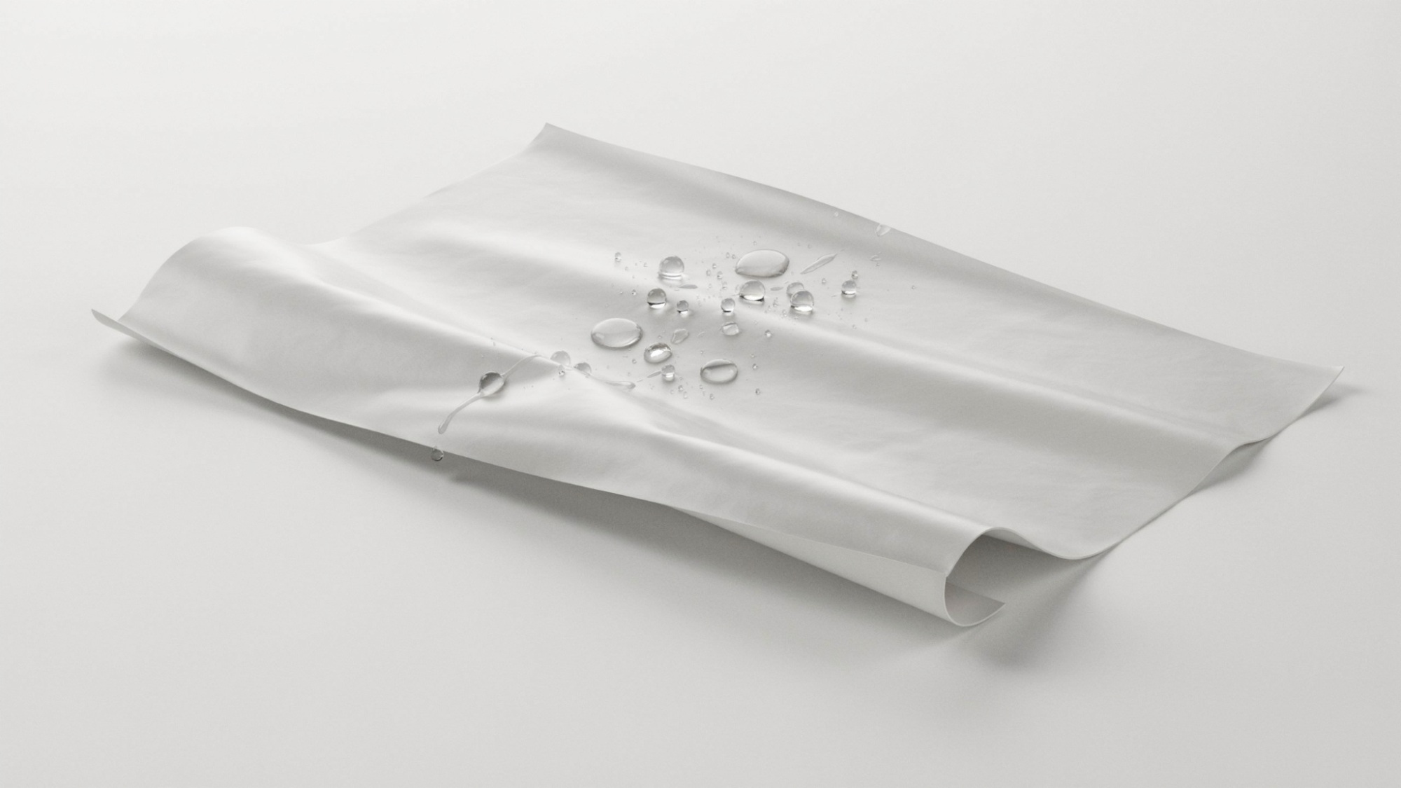 Water droplets beading on flexible waterproof PEVA material.