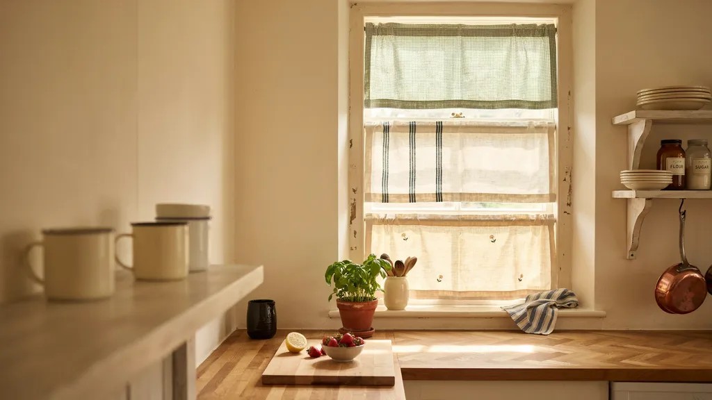 Tier curtains covering separate sections of a kitchen window.