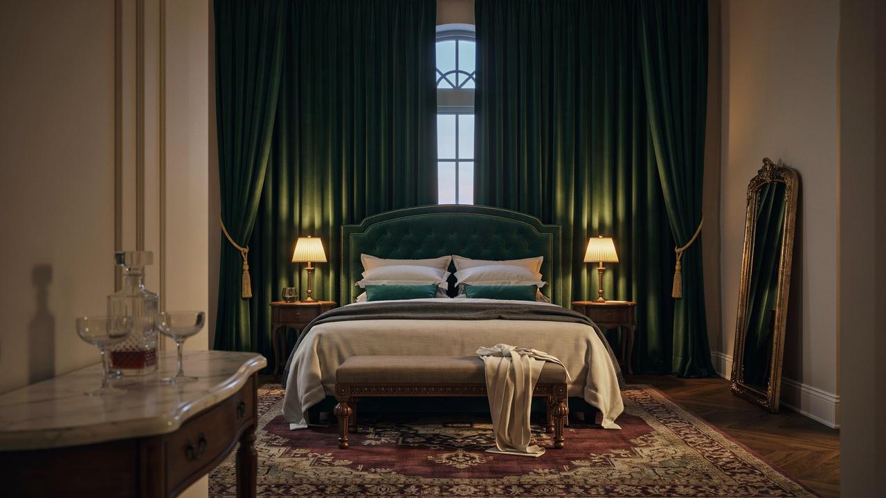Moody luxury bedroom with emerald velvet headboard, green drapes, vintage rug, gold mirror.